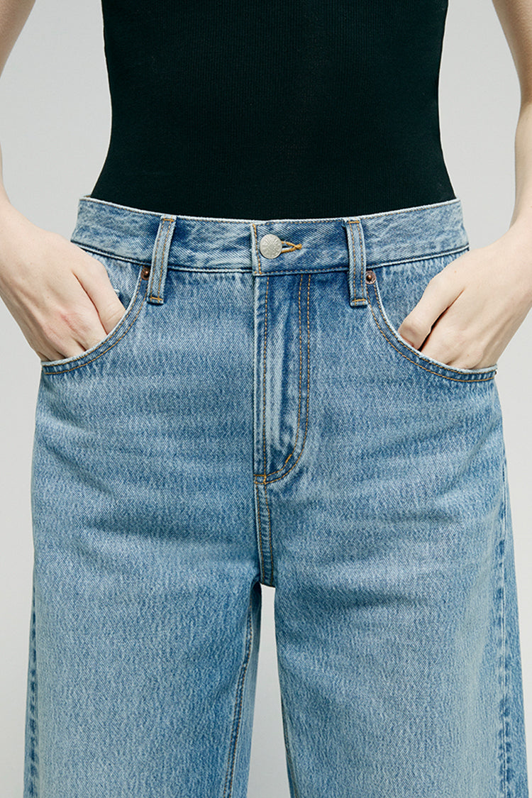 Hey Joanie Slope Curve Jeans HJ039 displayed on a hanger, showing classic high-rise denim with a relaxed fit and light wash.