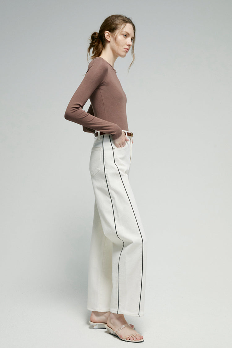 Hey Joanie Crush Curve ankle jeans in dark wash, slim fit with frayed hems, displayed on a hanger against a neutral background.