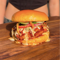 Vegan Fndly Hot Honey Fried Chicken Sandwich recipe image showing a crispy fried chicken sandwich with hot honey glaze on a bun.