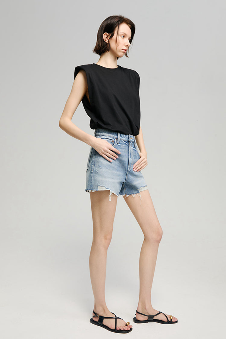 Hey Joanie Sun-Kissed Vintage Cut Off Shorts displayed on a hanger, featuring distressed denim and frayed edges.