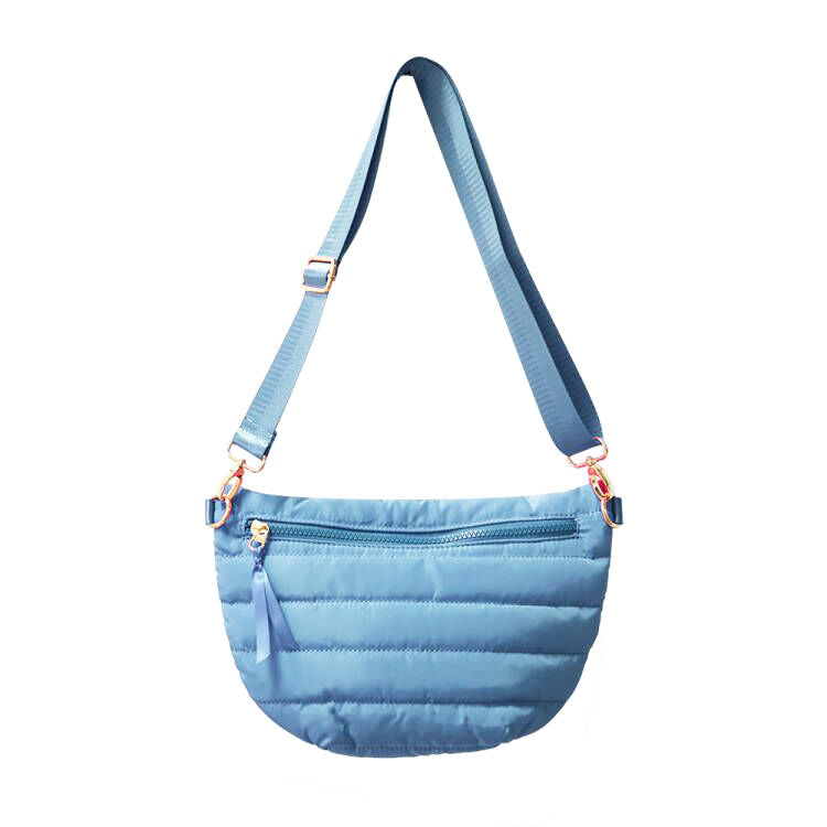 Babs+Birdie Crescent Puffer Sling Bag with quilted design and adjustable strap, stylish and lightweight for everyday use.