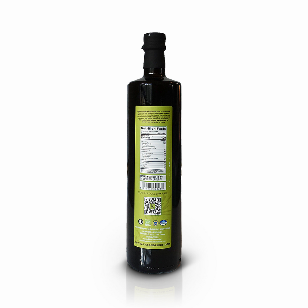 Back view of a 1-liter bottle of Kasandrinos International organic extra virgin olive oil with clear label and dark glass bottle