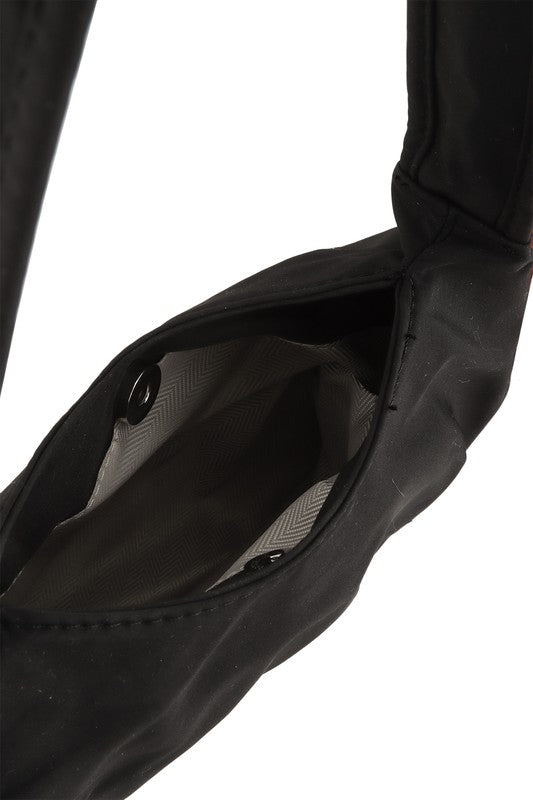 Hailey Brook Designs half moon shape crossbody handbag with adjustable strap and sleek design, shown in a neutral color.