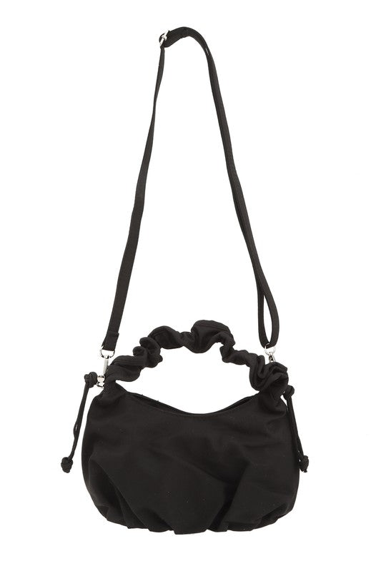Hailey Brook Designs half moon shape crossbody handbag with adjustable strap and modern design, in soft neutral color.