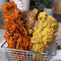 Vegan Fndly fried enoki mushroom recipe with crispy golden enoki mushrooms garnished with herbs and served on a plate.