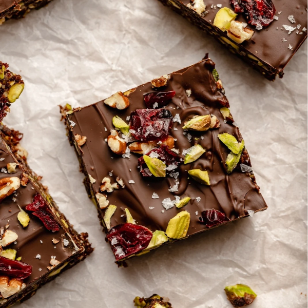 Vegan Fndly superfood brownies recipe image showing a delicious, healthy chocolate brownie topped with nuts and seeds.