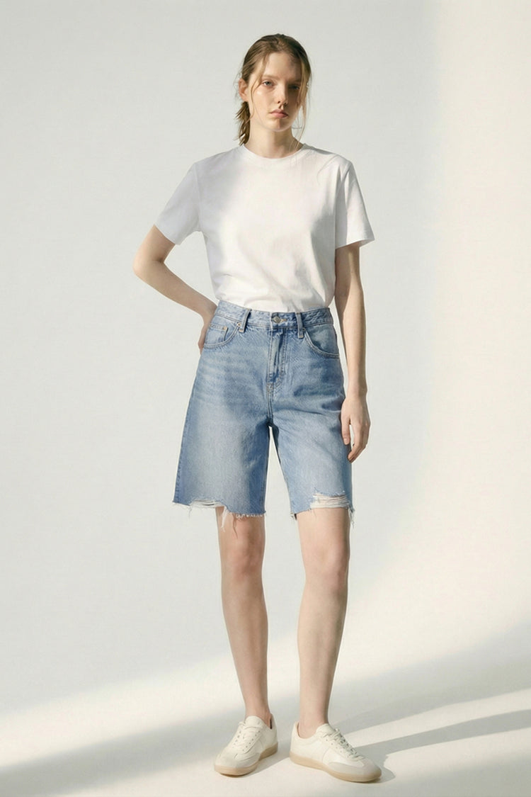 Hey Joanie Coastal Breeze 90's Bermuda Shorts in light blue with a relaxed fit and vintage-inspired design, displayed on a wooden background.