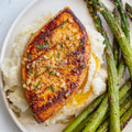 Vegan Fndly garlic butter tofu recipe image showing crispy tofu cubes glazed with garlic butter and herbs on a white plate.