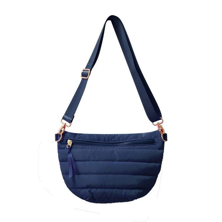 Babs+Birdie Crescent Puffer Sling Bag with quilted design and adjustable strap, stylish and compact for everyday use.