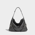 Designer shoulder handbag by In Orderly Fashion, featuring a stylish bag with sleek straps and elegant design details.