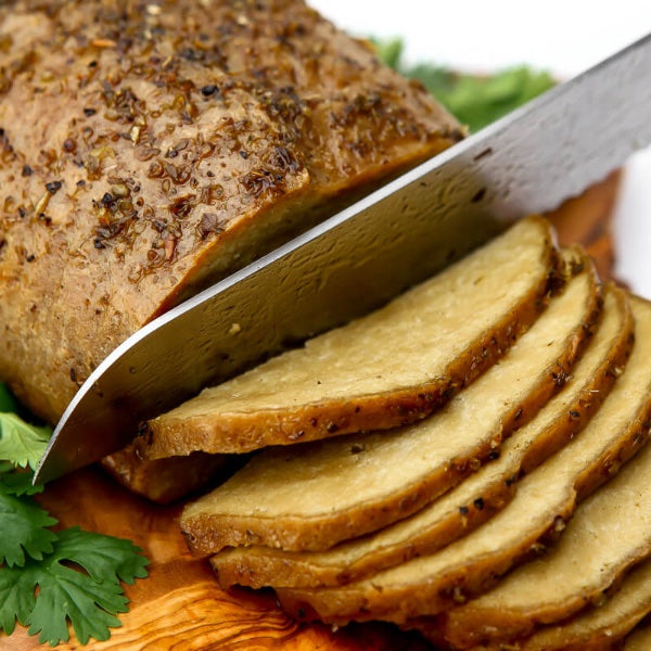 Vegan Fndly Vegan Turkey Roast Recipe with a plated roasted turkey-style dish on a serving platter, garnished with herbs.