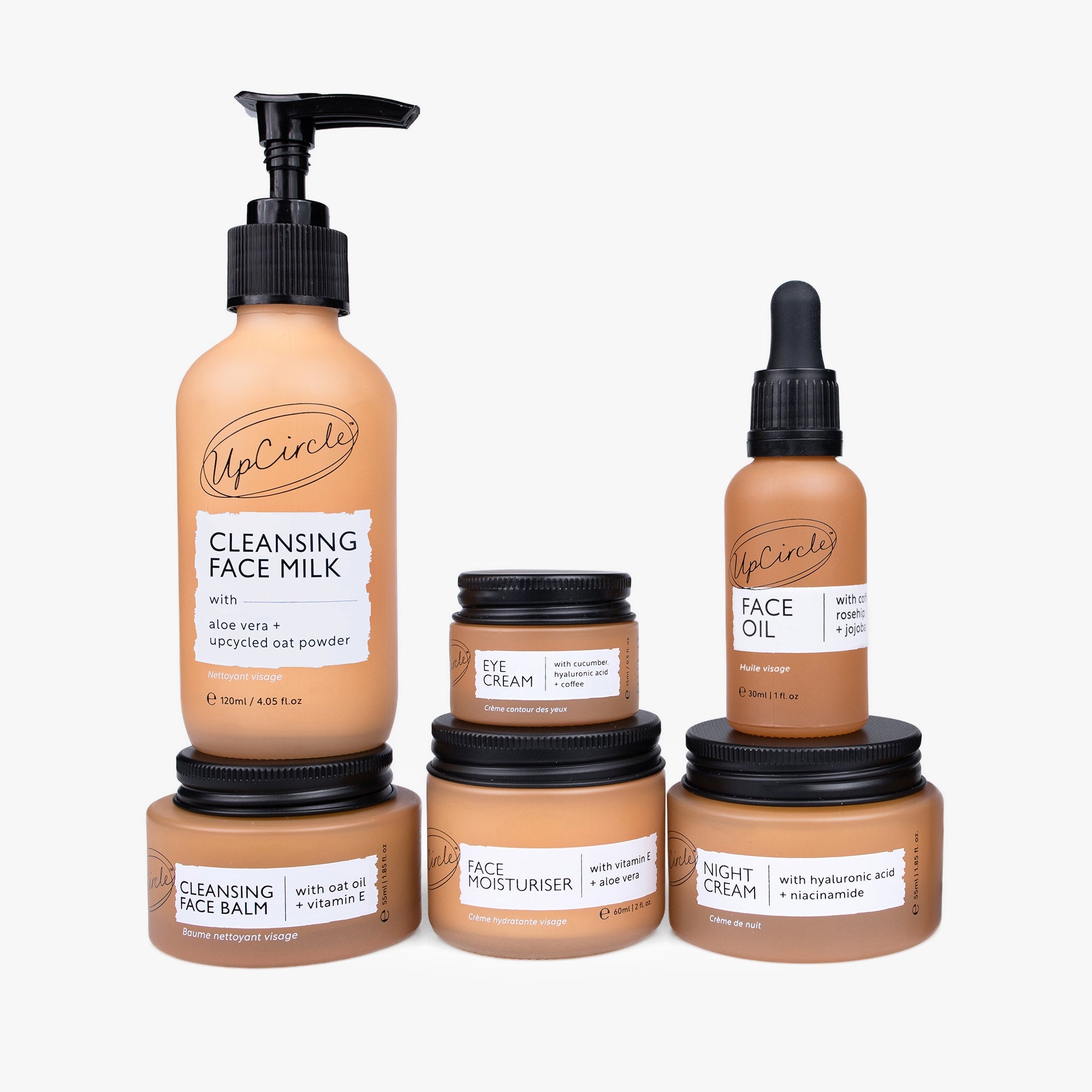 UpCircle anti-aging skincare bundle with various creams and serums displayed in a natural setting, highlighting eco-friendly packaging.