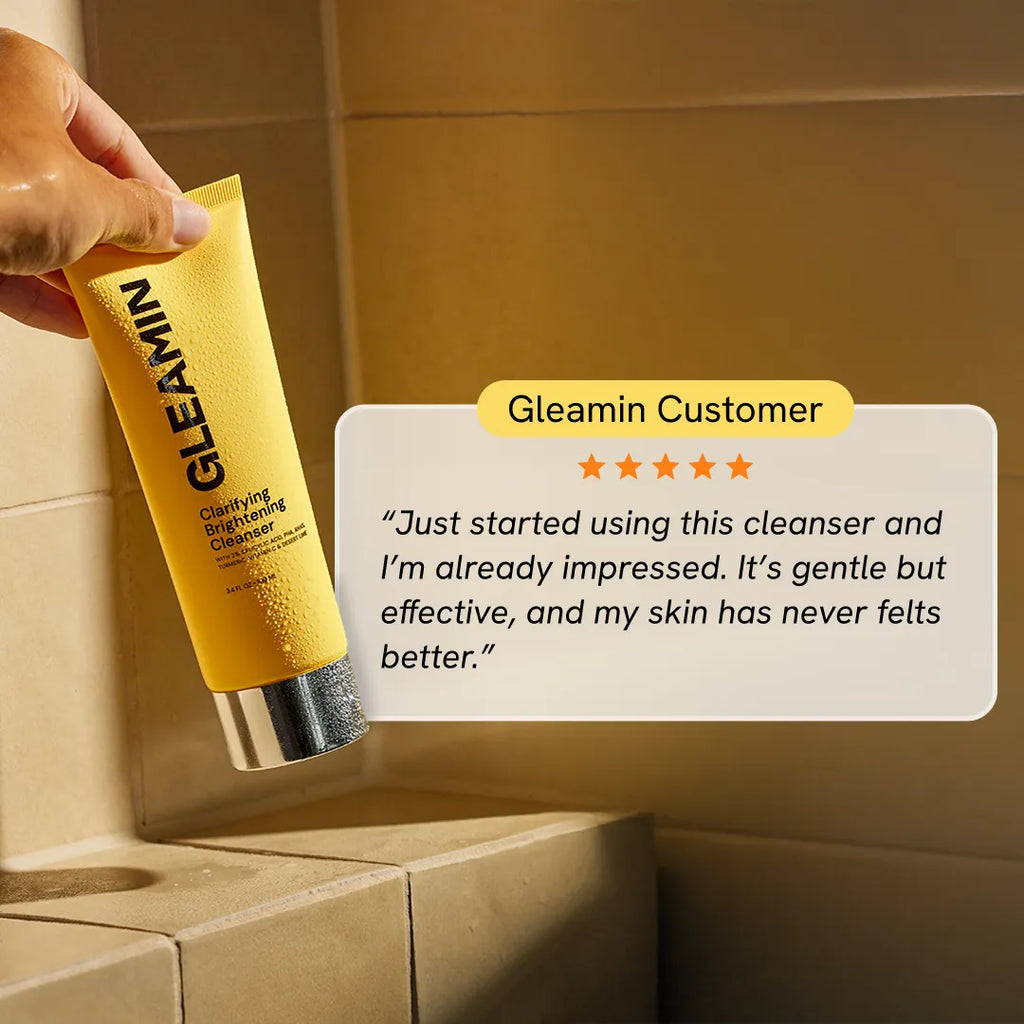 Gleamin Clarifying Brightening Cleanser in a clear bottle, showing the facial cleanser with a smooth, foamy texture and clean design.