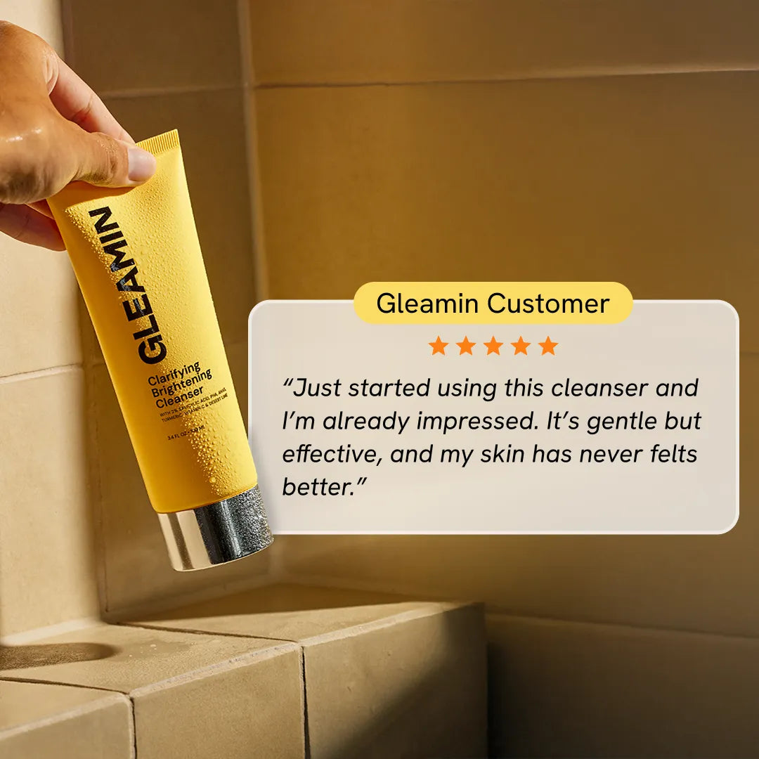 Gleamin Clarifying Brightening Cleanser in a clear bottle, showing the facial cleanser with a smooth, foamy texture and clean design.