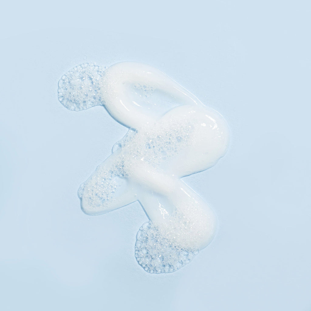 Somme Institute nourishing cleanser in a cream formula with foam bubbles, designed for gentle, non-drying skincare.