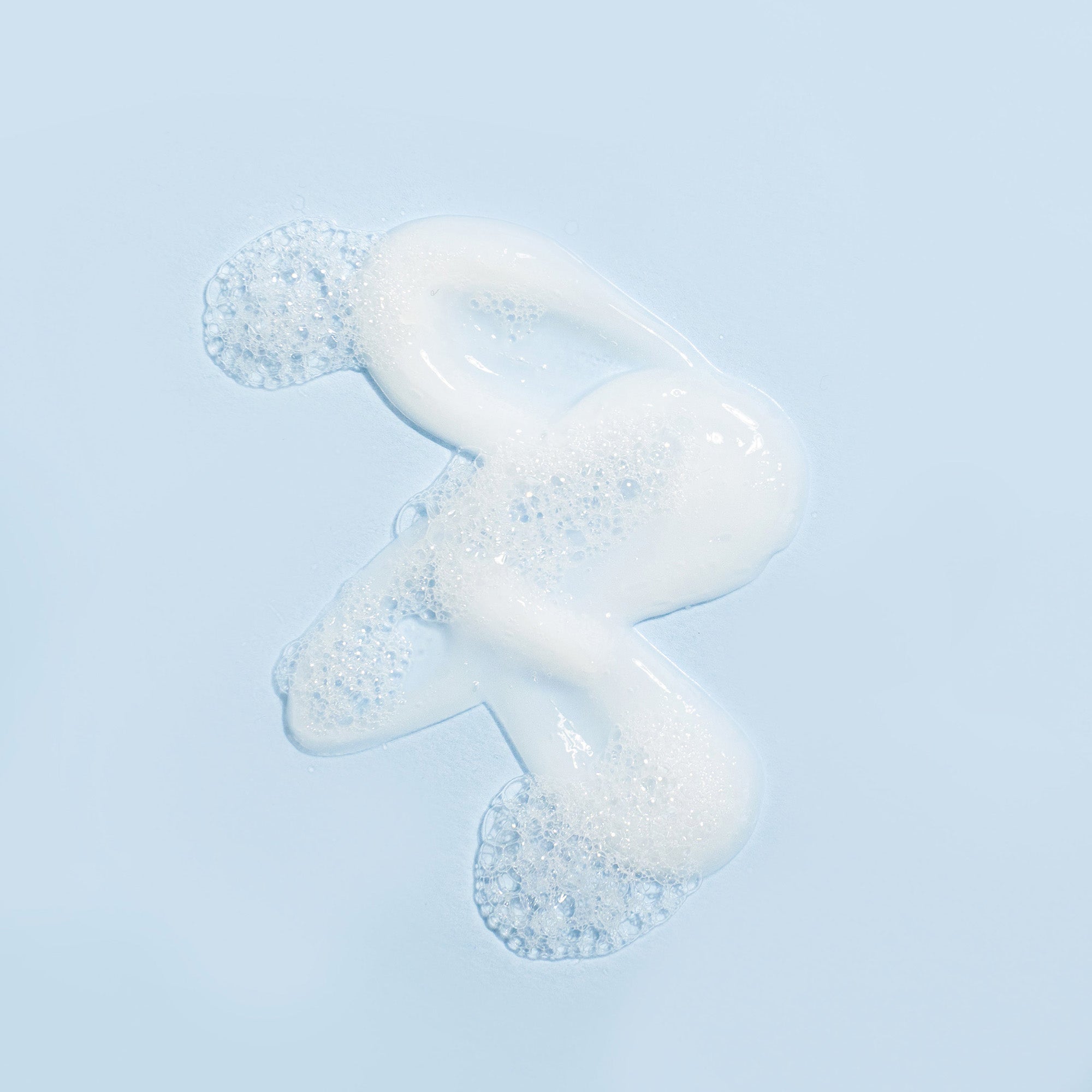 Somme Institute nourishing cleanser in a cream formula with foam bubbles, designed for gentle, non-drying skincare.