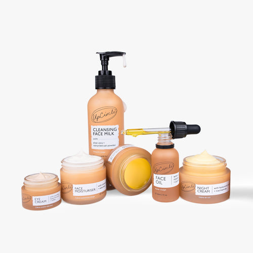 Open jar of UpCircle anti-aging skincare bundle featuring creams and serums in a natural skincare set.