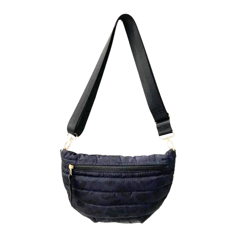 Babs+Birdie Crescent Puffer Sling Bag in quilted design with adjustable strap, shown in a sleek, modern style.