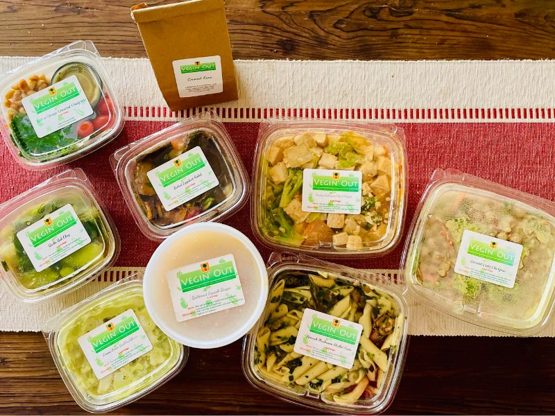 Vegin' Out vegan meal delivery set with fresh vegetarian and vegan dishes arranged on a table.