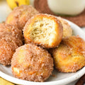 Vegan Fndly banana donut holes on a plate, showcasing golden, bite-sized banana donut treats with a crispy coating.