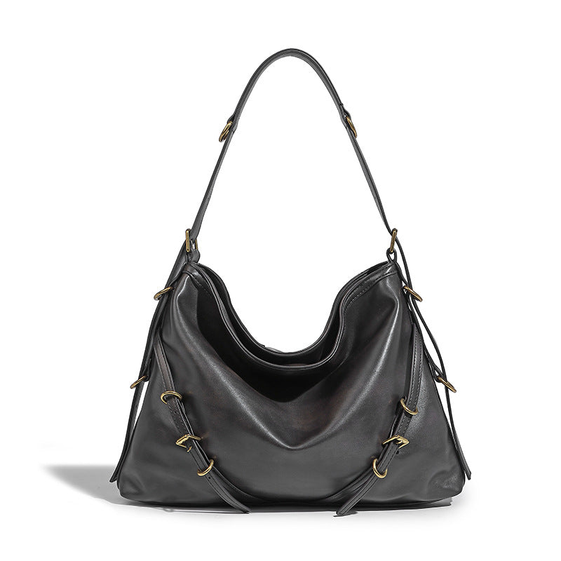 In Orderly Fashion designer shoulder handbag with sleek design, featuring a structured shape and stylish strap on a neutral background.