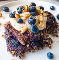 Vegan Fndly Quinoa Berry Bake recipe image showcasing a baked dish with fresh berries and quinoa in a ceramic baking dish.