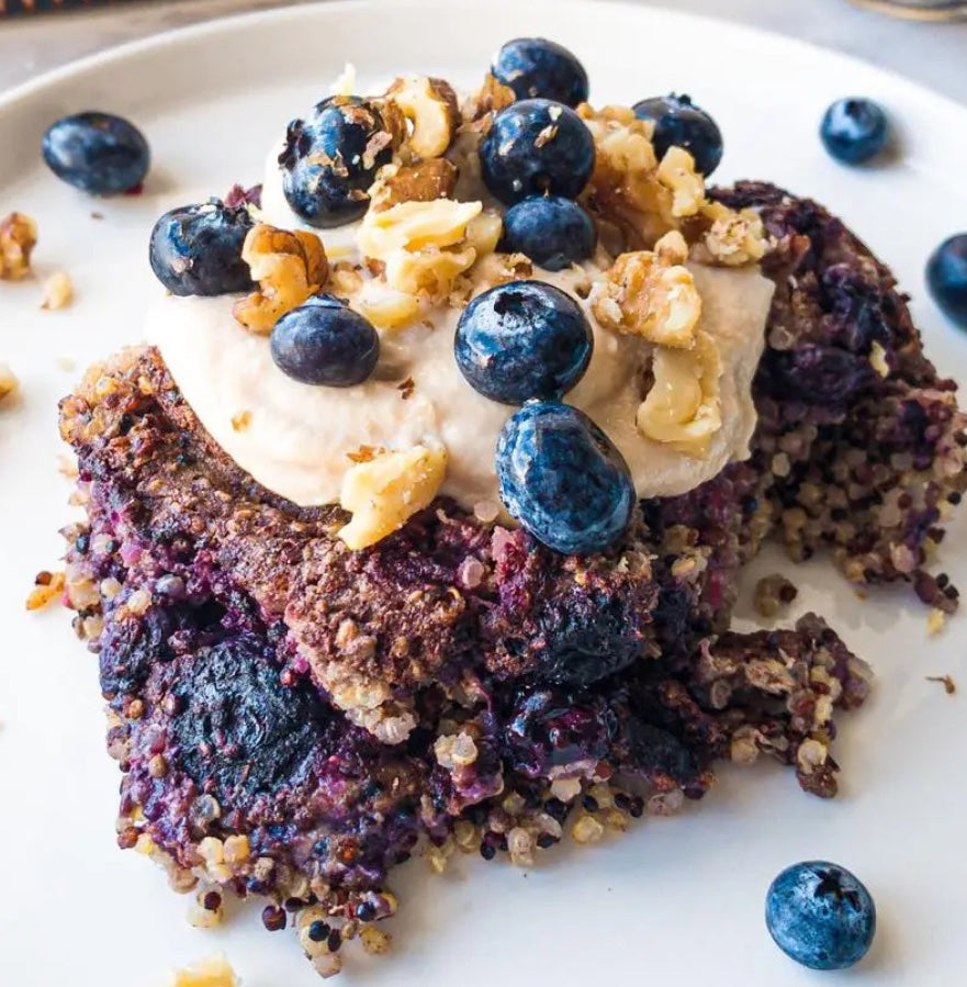 Vegan Fndly Quinoa Berry Bake recipe image showcasing a baked dish with fresh berries and quinoa in a ceramic baking dish.