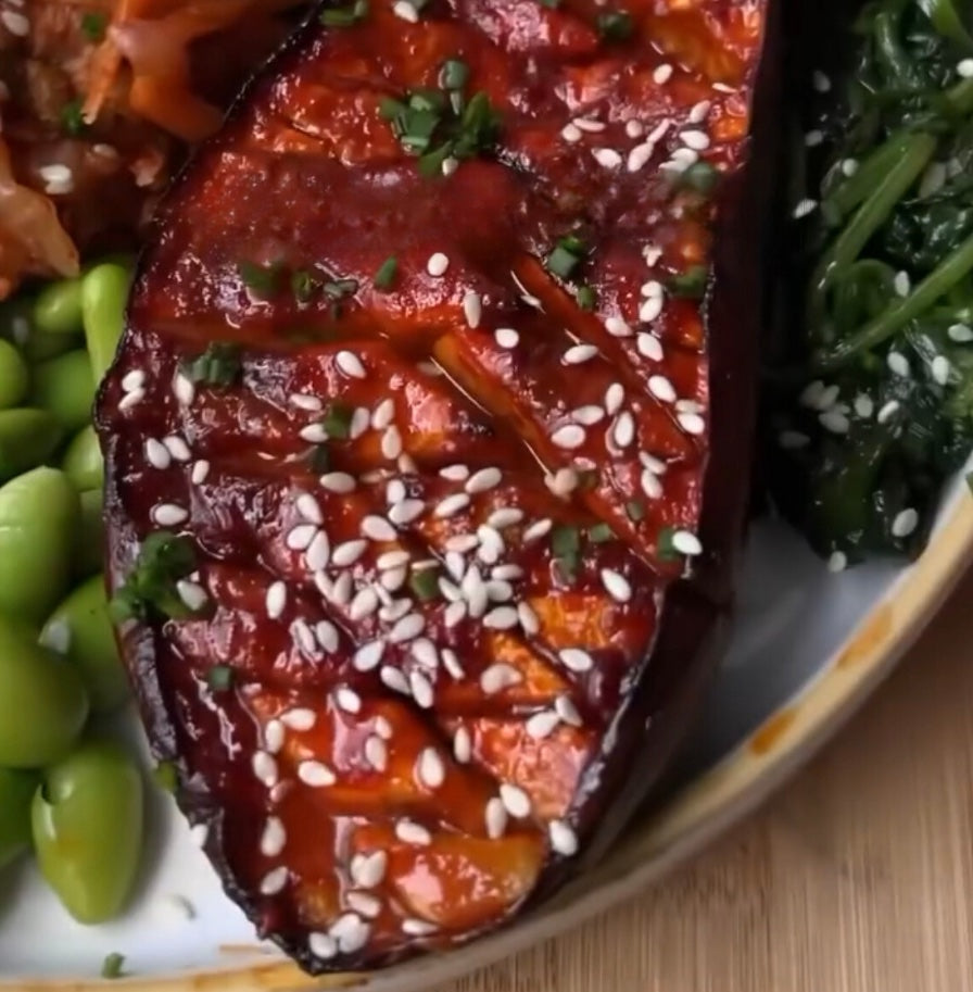 Vegan Fndly Gochujang Aubergine recipe image showing roasted aubergine slices glazed with spicy gochujang sauce.
