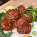 Vegan Lemongrass Tofu Meatballs served on a plate, garnished with herbs, showcasing a flavorful plant-based recipe by Vegan Fndly.