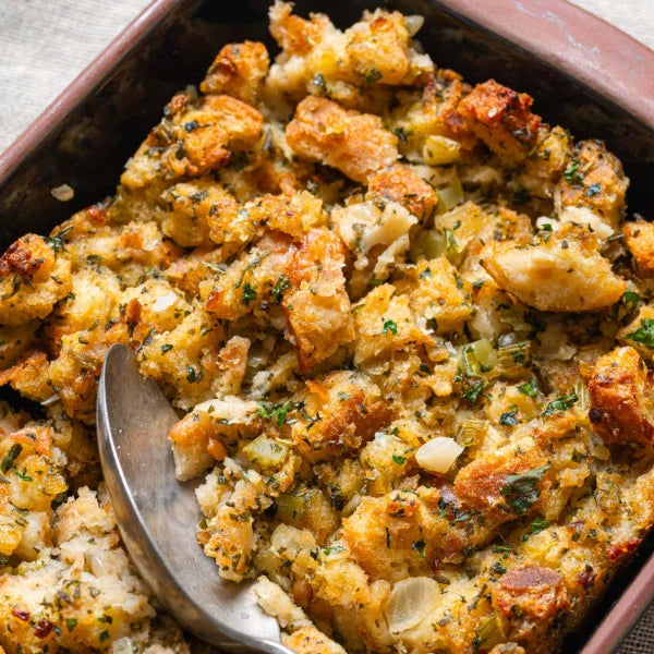 Vegan Fndly vegan stuffing recipe with fresh vegetables, herbs, and seasonings in a baking dish, ready for cooking.