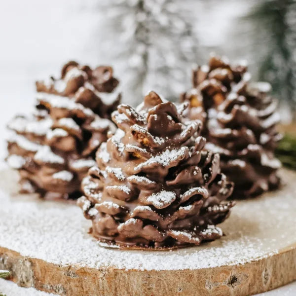 Vegan Pine Cone Truffles recipe by Vegan Fndly, showing pine cone-shaped vegan chocolate truffles on a plate.