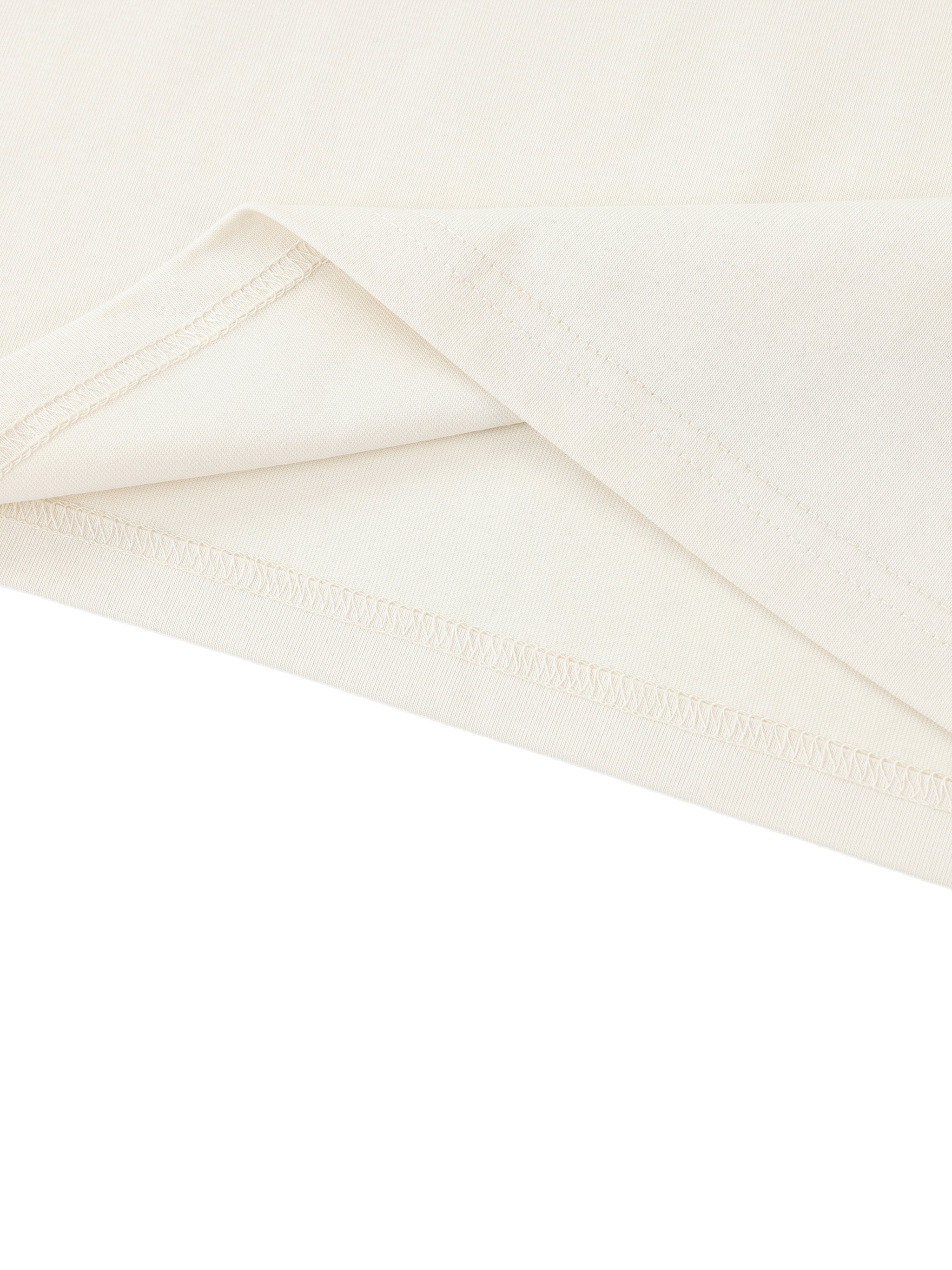 White ODMPOD Essential Standard Shoulder T-Shirt displayed on a model, showcasing its comfortable fit and classic design.