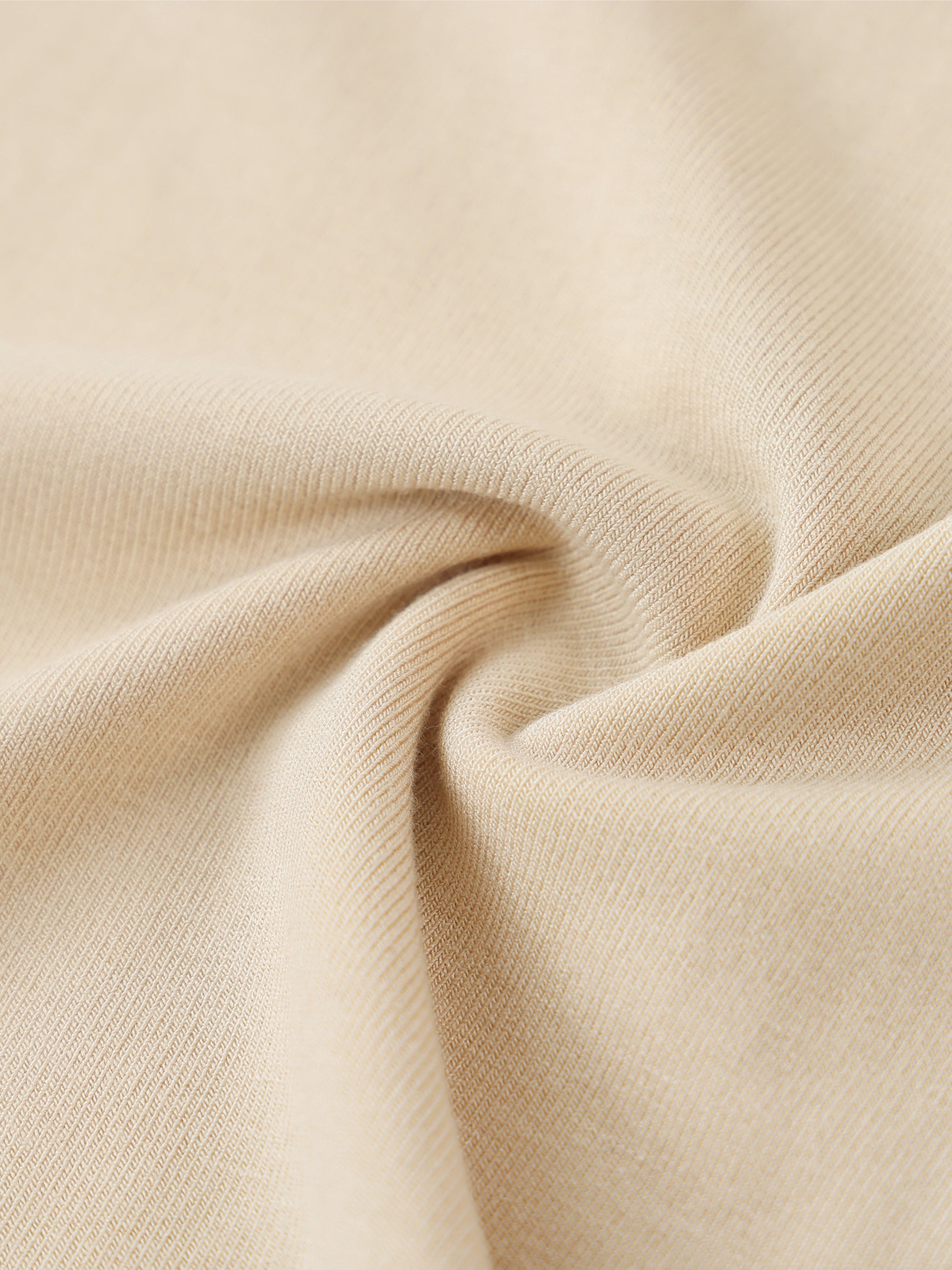 ODMPOD essential mock neck long sleeve T-shirt in white, showing a close-up of the soft fabric and fitted style.