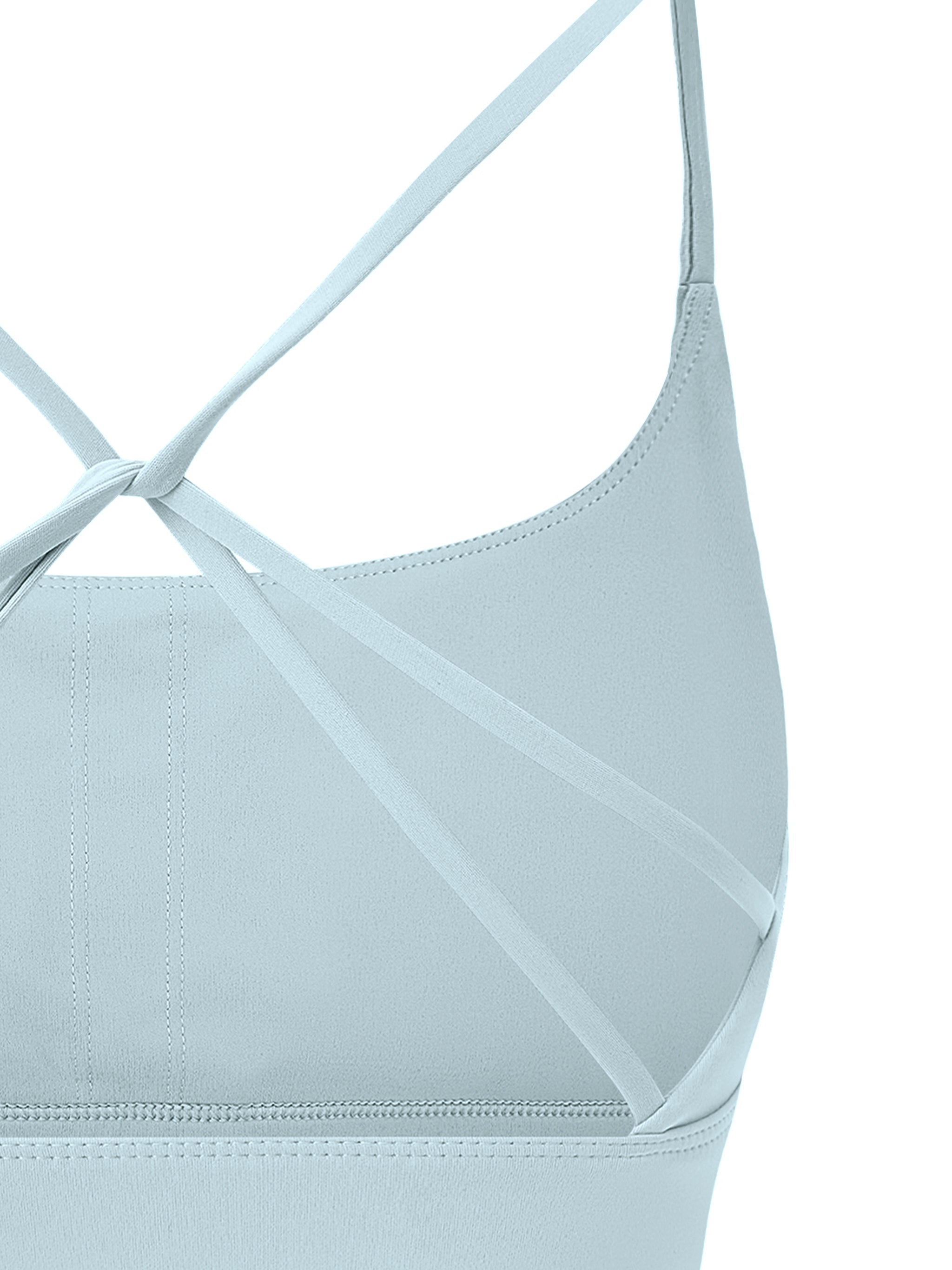 ODMPOD strappy criss cross yoga sports bra with stylish design and supportive fit, shown on a white background.