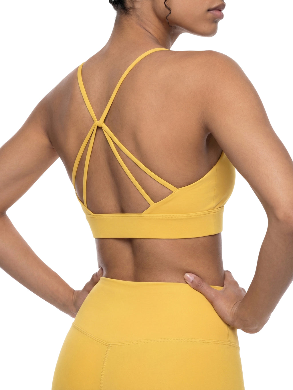 ODMPOD strappy criss cross yoga sports bra with adjustable straps and supportive fit, shown on a neutral background.