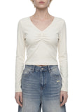 ODMPOD ruched long sleeve crop T-shirt featuring fitted design and stylish ruched detail in soft fabric.