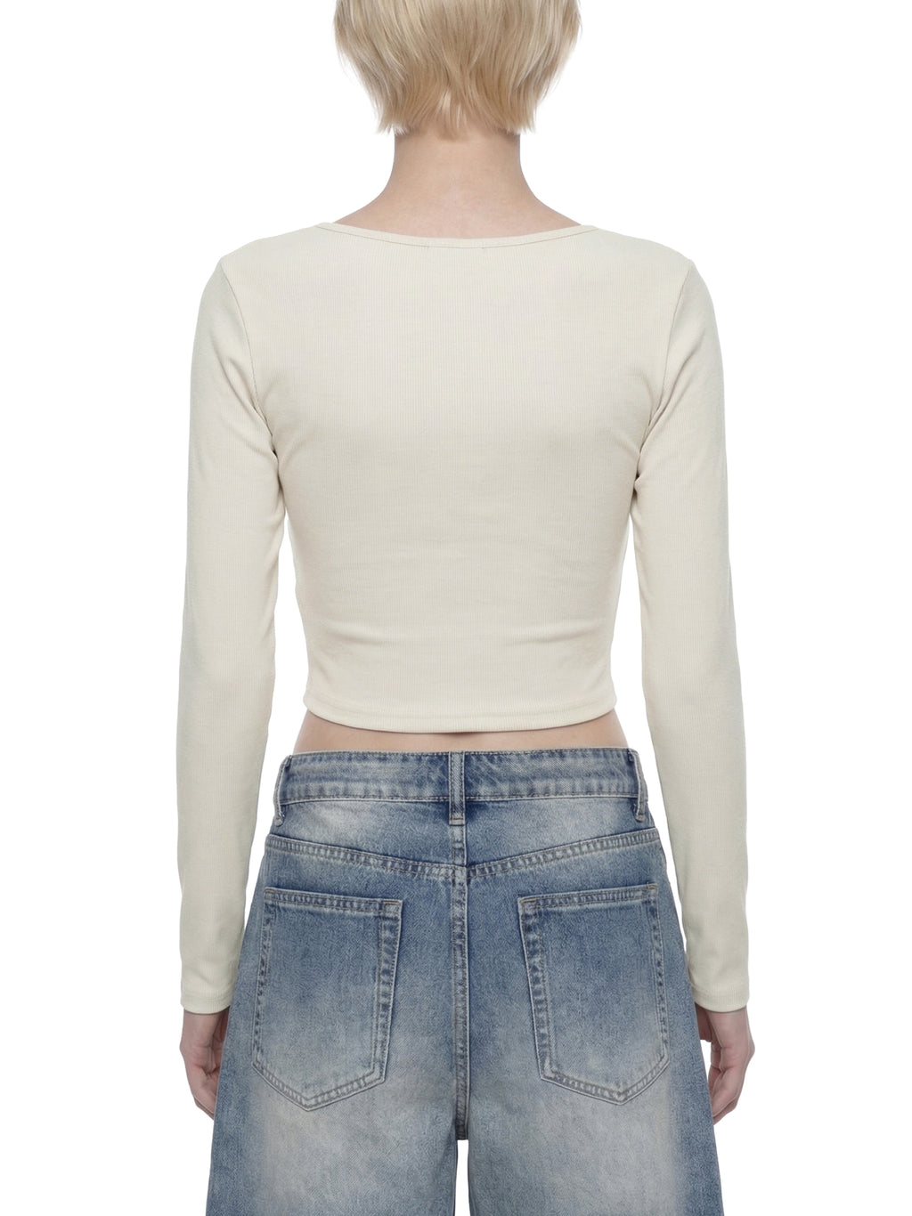 ODMPOD ruched long sleeve crop T-shirt displayed on a model, featuring a fitted style with ruching details and long sleeves.