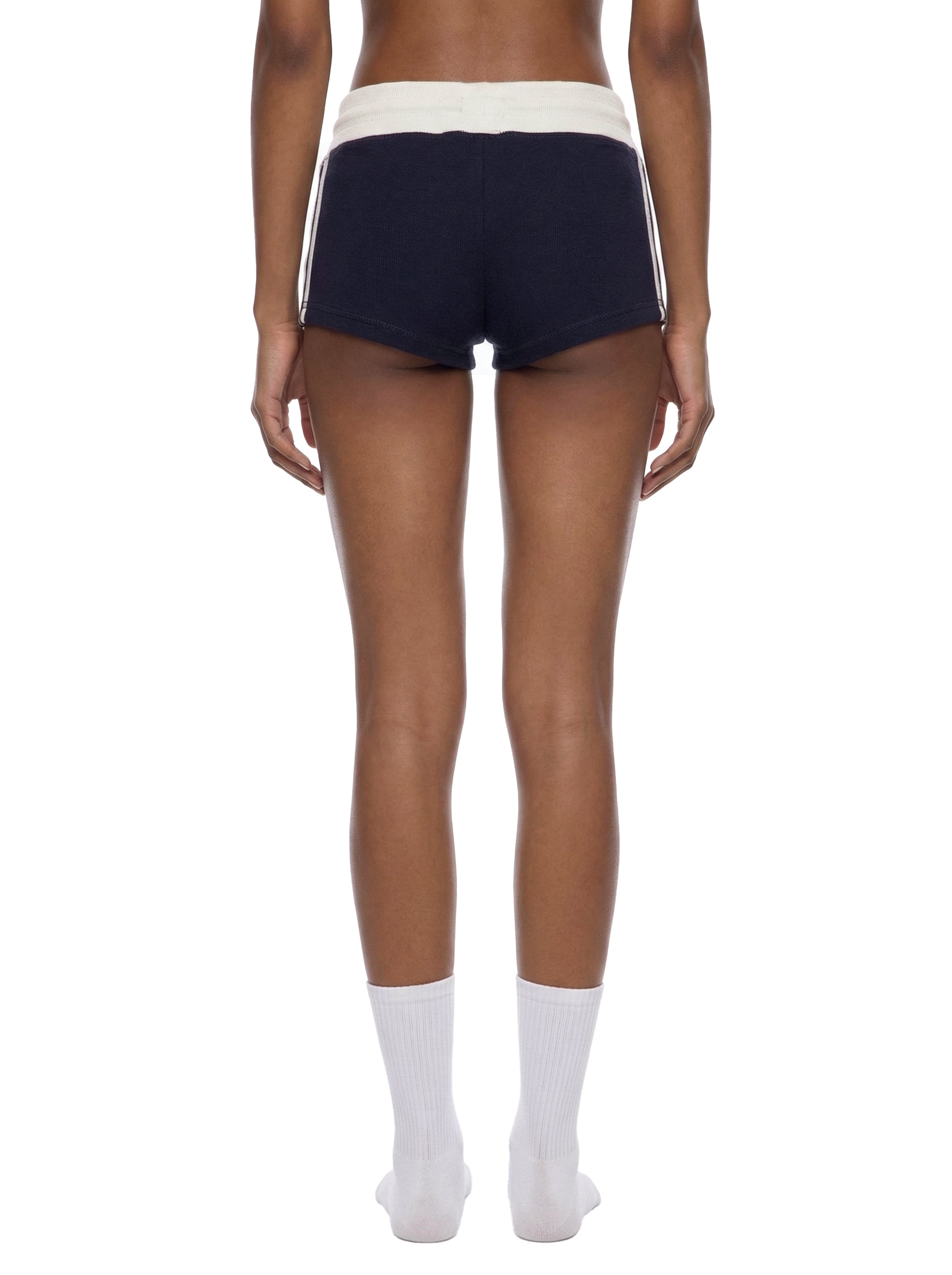 ODMPOD contrast stripe track shorts showing a sporty design with black and white color blocking and comfortable elastic waistband.