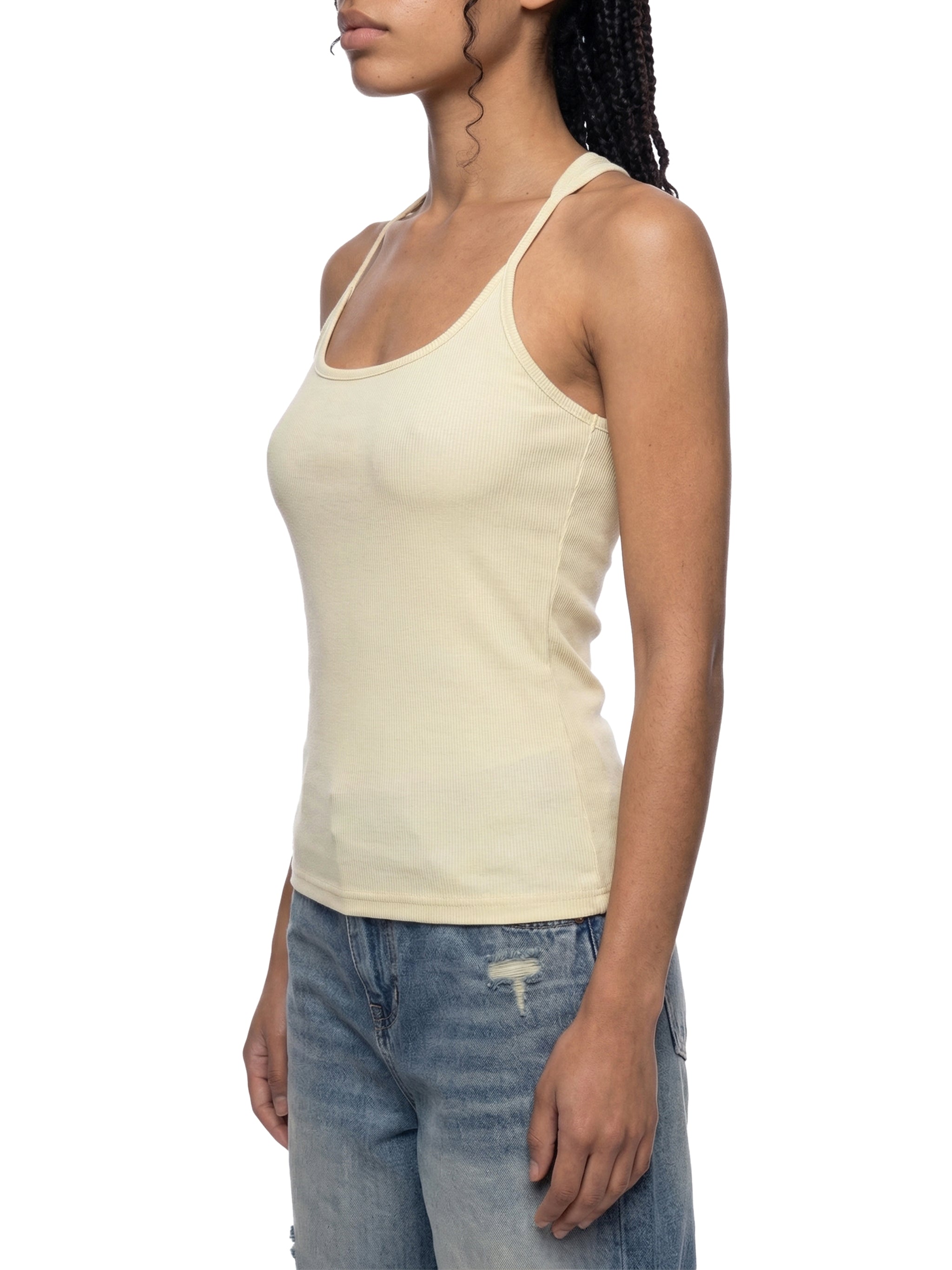 Slim fit ribbed racerback tank top by ODMPOD, shown in a close-up of the textured fabric and sleeveless design.