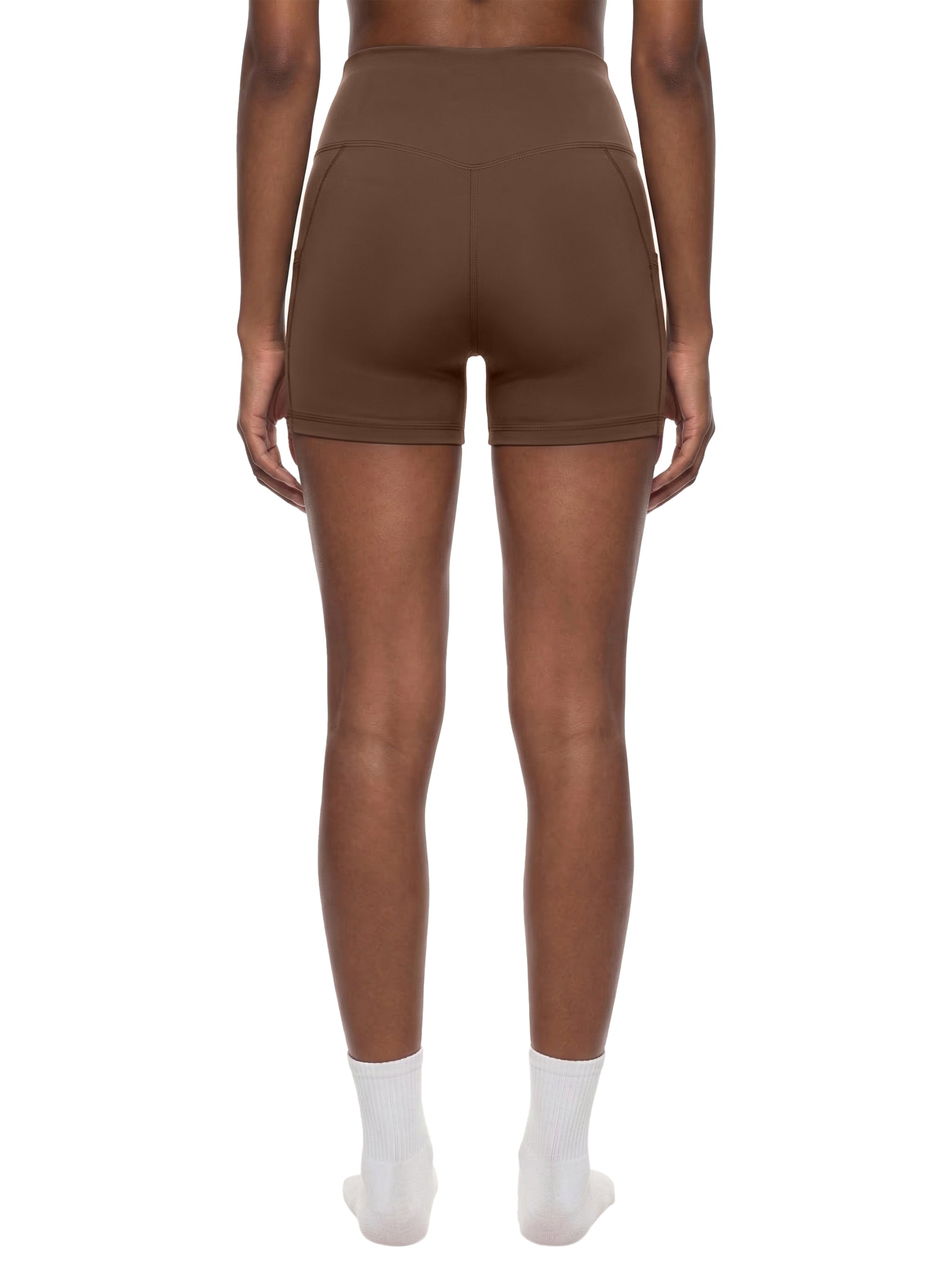 Black high-waisted pocket biker shorts by ODMPOD, featuring a snug fit and functional side pockets.