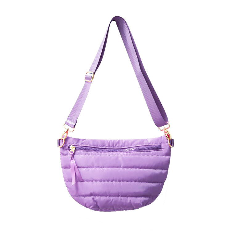 Babs+Birdie crescent puffer sling bag in vibrant purple with quilted design and adjustable strap.